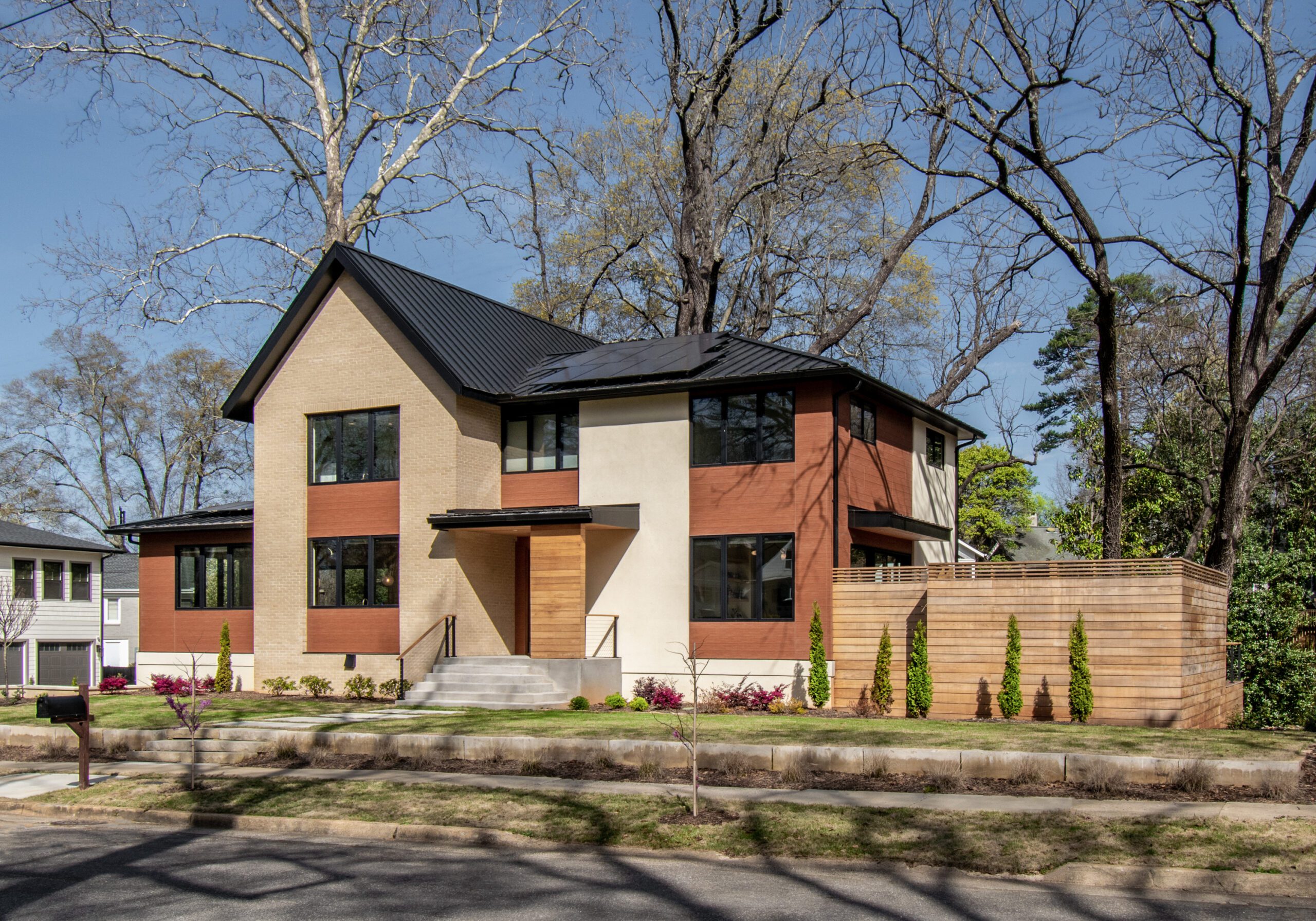 Modern house exterior with brick stucco wood accents black windows