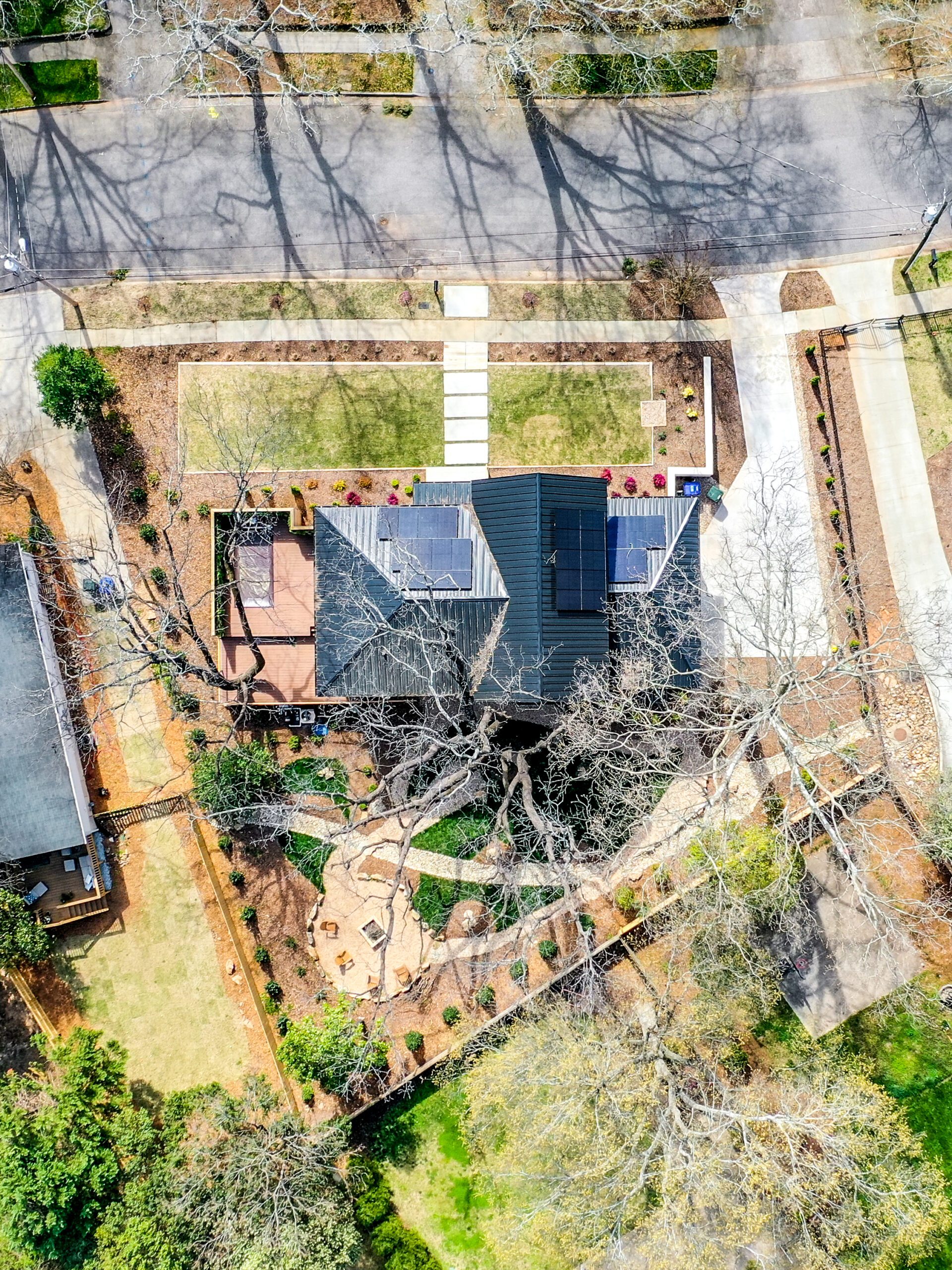 Drone view of black metal roof with solar panels