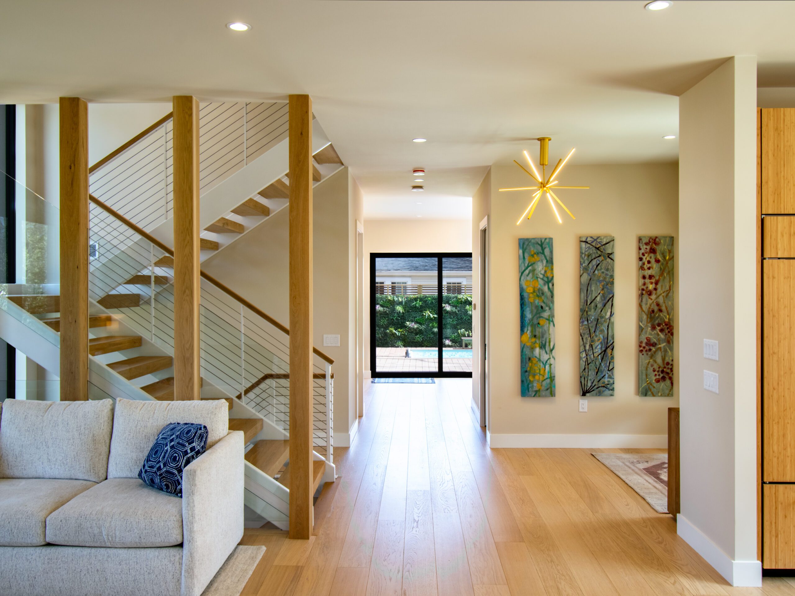 White steel stairs white oak flooring and white oak wrapped columns