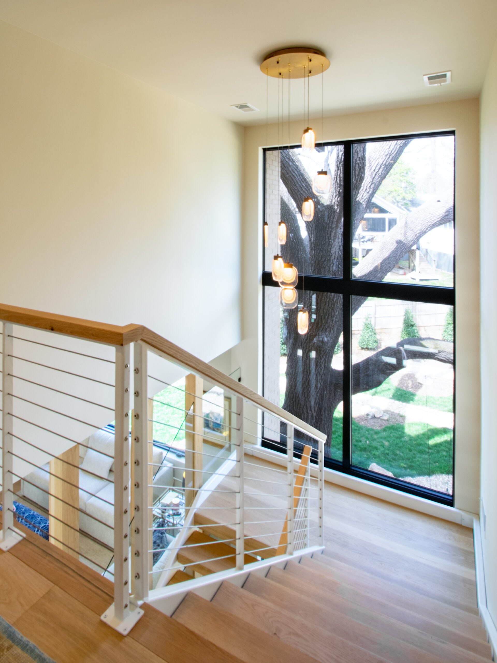 Double height window at modern open riser stair