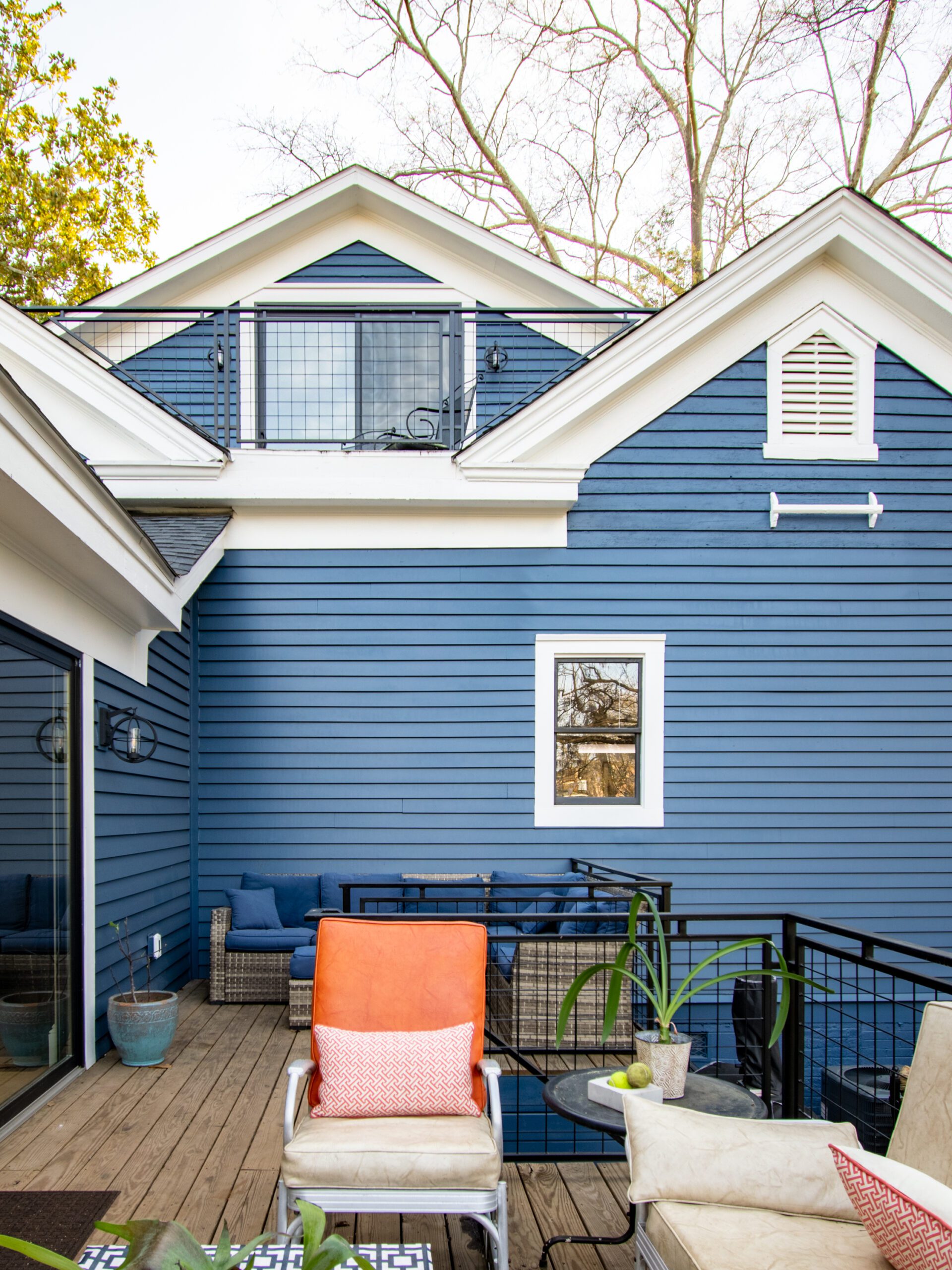 View of back deck and facade of renovated Victorian home