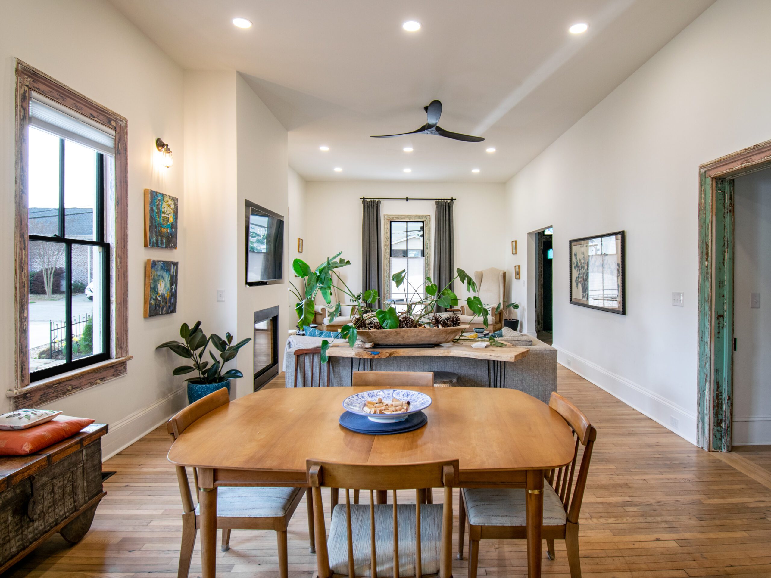 View of open living and dining room in renovated Victorian house