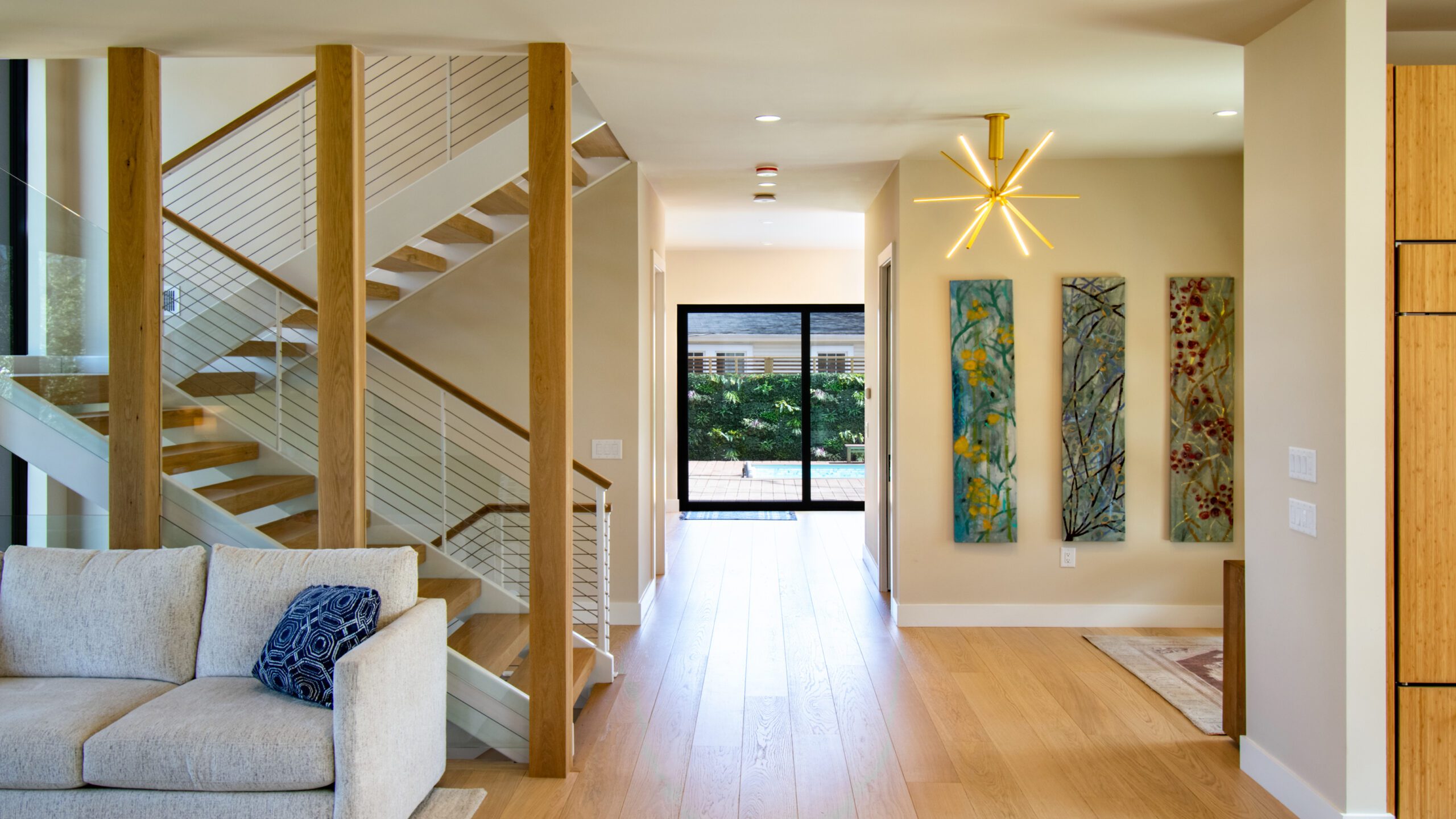 White steel stairs white oak flooring and white oak wrapped columns